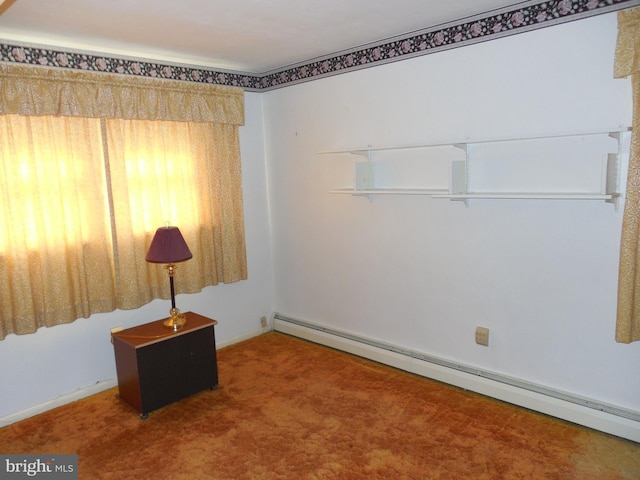 carpeted empty room with a baseboard heating unit