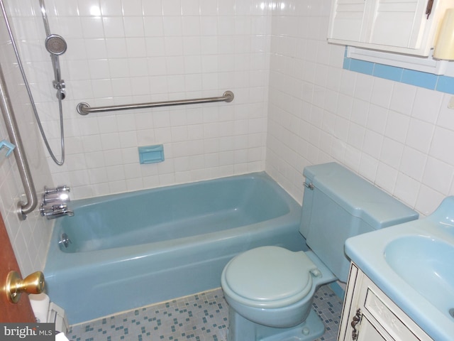 full bathroom featuring vanity, tiled shower / bath combo, and toilet