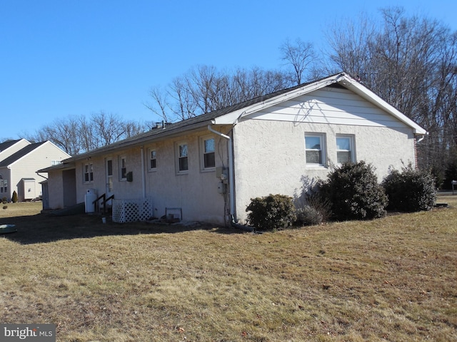 view of side of home featuring a yard