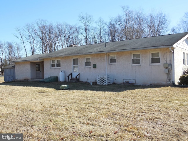 back of property featuring a yard