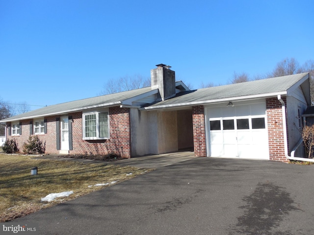 ranch-style house featuring a garage