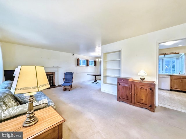 living room featuring light carpet, sink, and a fireplace