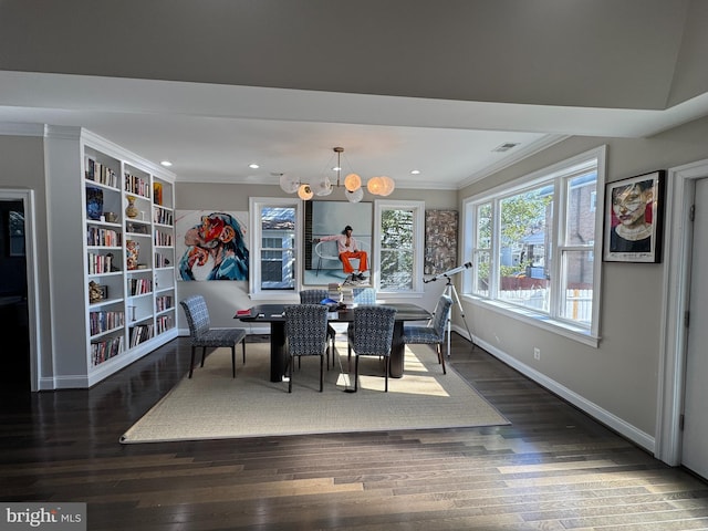 dining area featuring crown molding, an inviting chandelier, and dark hardwood / wood-style flooring