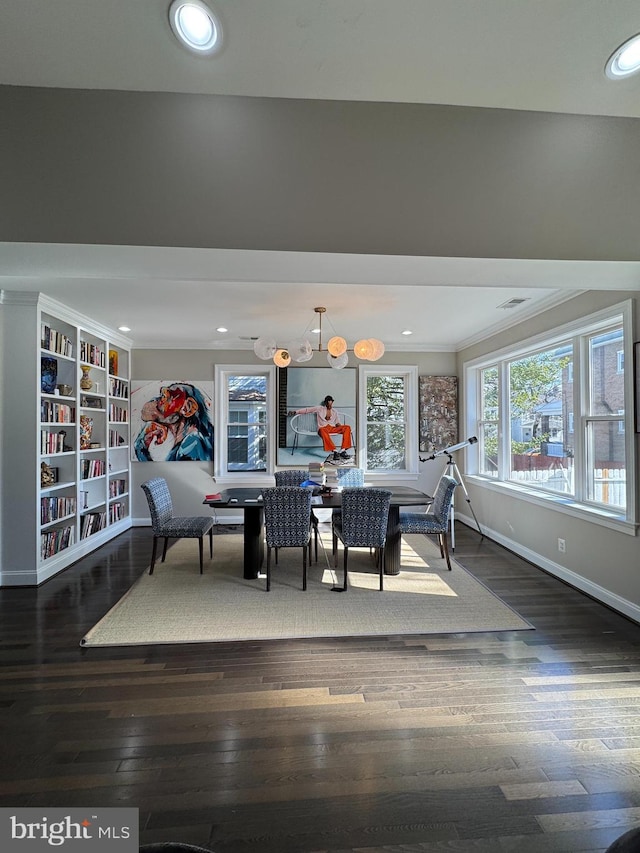 dining room with ornamental molding and dark hardwood / wood-style floors