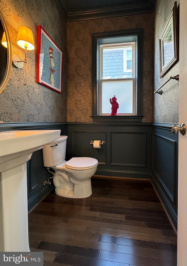 bathroom featuring ornamental molding, toilet, and hardwood / wood-style floors