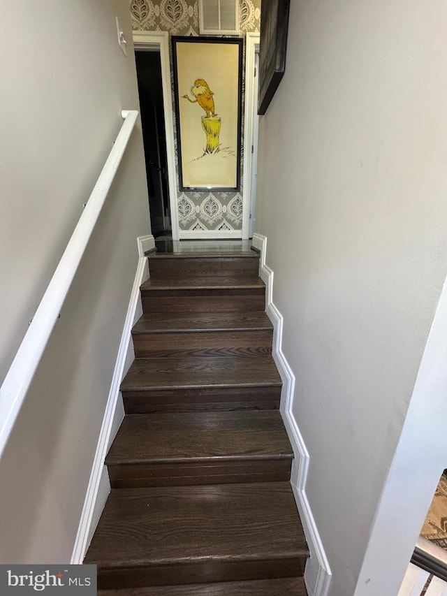 stairs with wood-type flooring