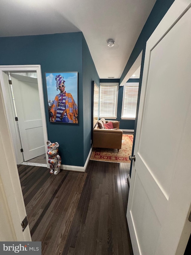 hallway with dark hardwood / wood-style floors