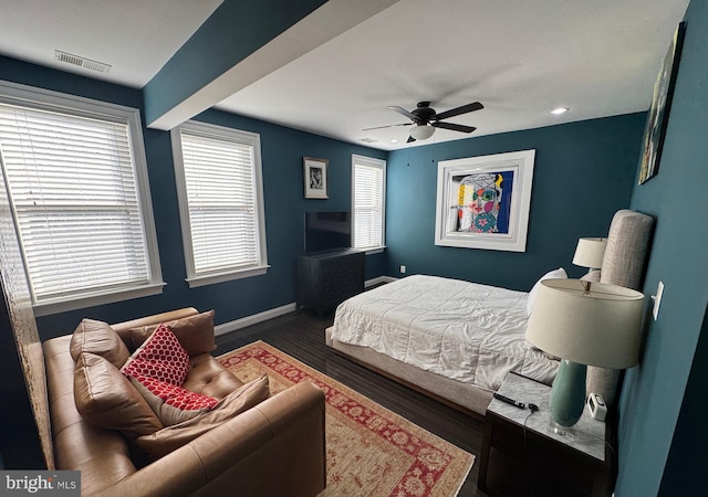 bedroom with ceiling fan and dark hardwood / wood-style floors