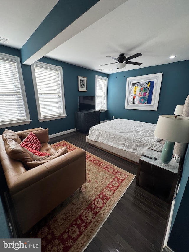 bedroom with ceiling fan and dark hardwood / wood-style floors