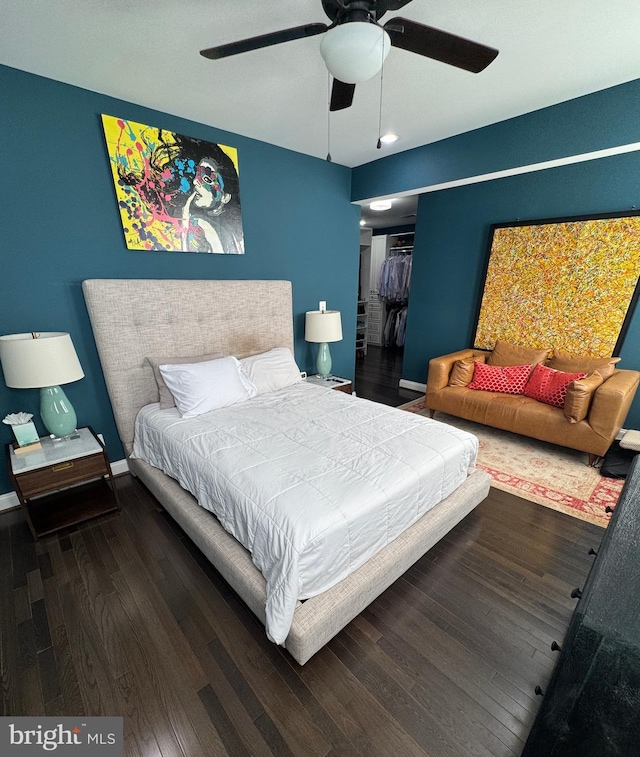 bedroom with dark wood-type flooring, a closet, and ceiling fan