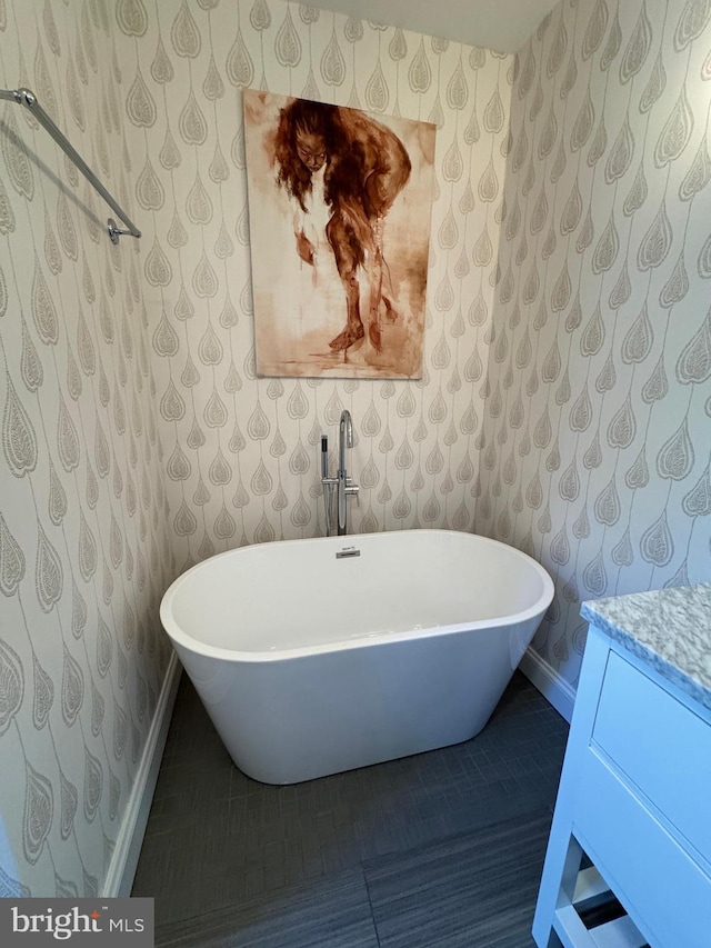 bathroom featuring a washtub and tile patterned floors