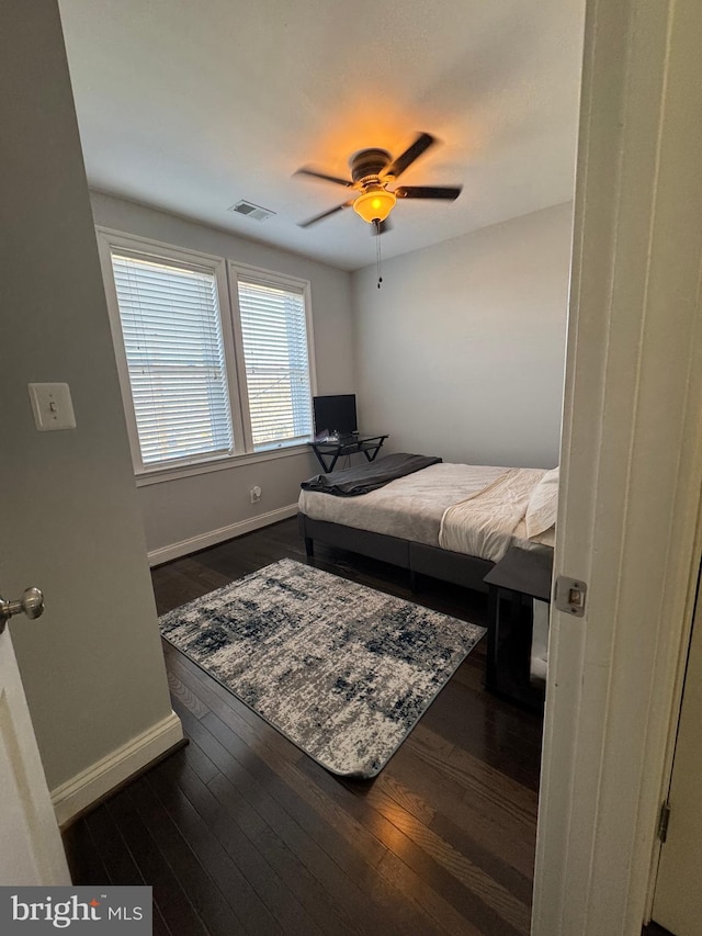 bedroom featuring dark hardwood / wood-style flooring and ceiling fan