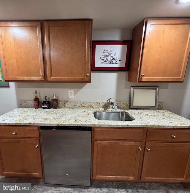 kitchen with dishwashing machine, light stone countertops, sink, and stainless steel fridge