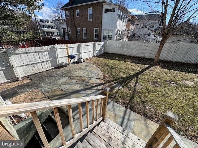 deck featuring a patio area and a lawn