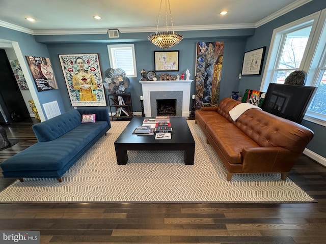 living room featuring hardwood / wood-style flooring, ornamental molding, and a healthy amount of sunlight