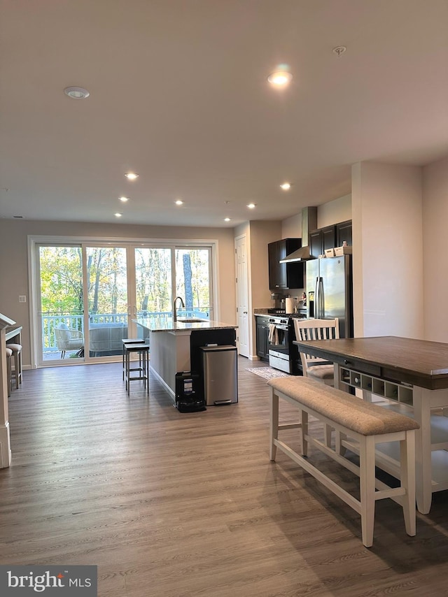 dining area featuring sink, a healthy amount of sunlight, and light wood-type flooring