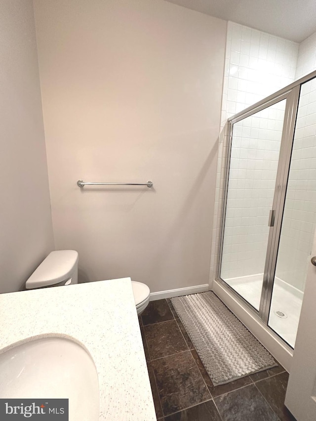 bathroom with walk in shower, toilet, and sink