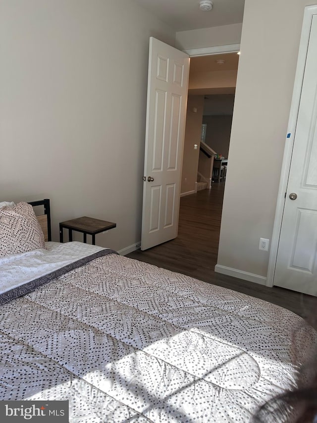 bedroom with dark wood-type flooring