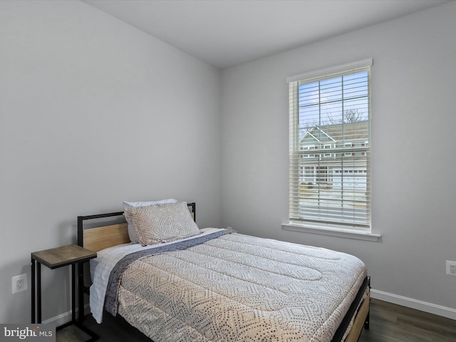 bedroom with dark hardwood / wood-style floors