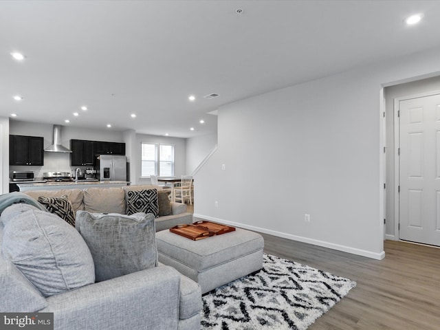 living room featuring hardwood / wood-style flooring and sink