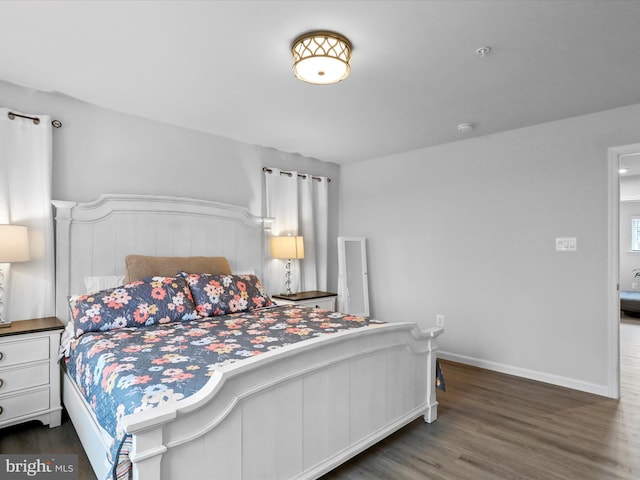 bedroom with dark hardwood / wood-style flooring