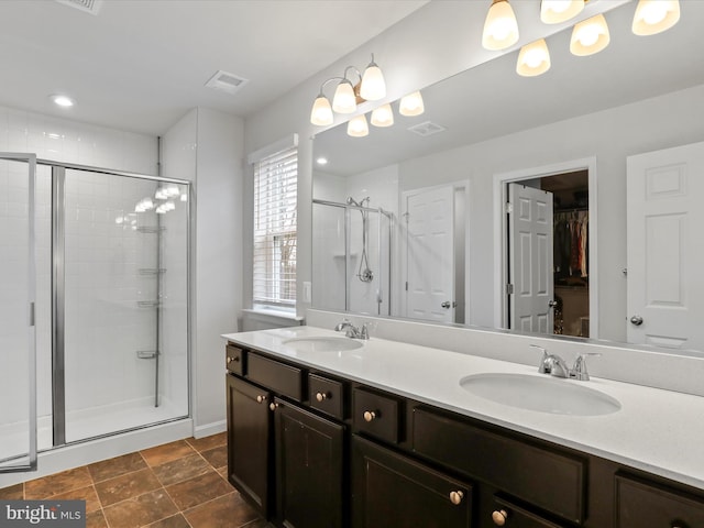 bathroom with vanity and a shower with door