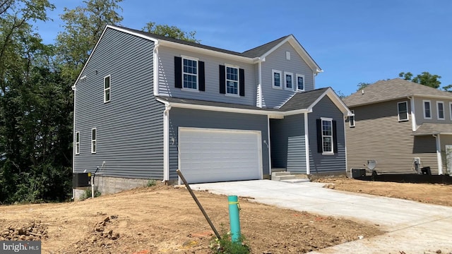 front facade featuring a garage and central AC unit