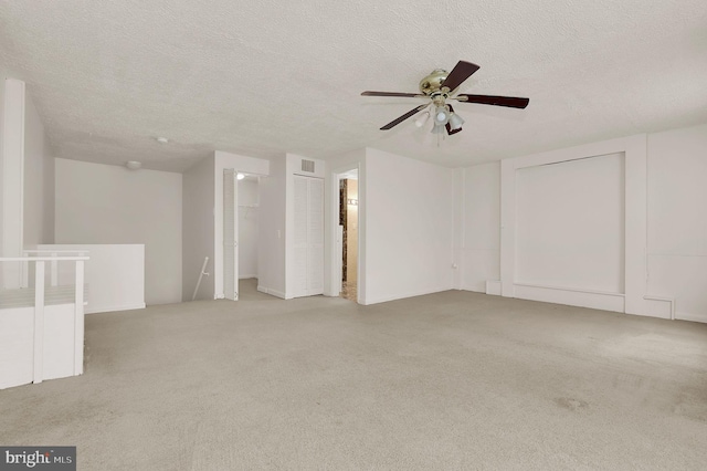 carpeted empty room with a textured ceiling