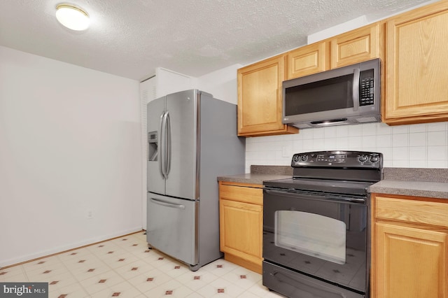 kitchen with stainless steel appliances, light brown cabinetry, and decorative backsplash