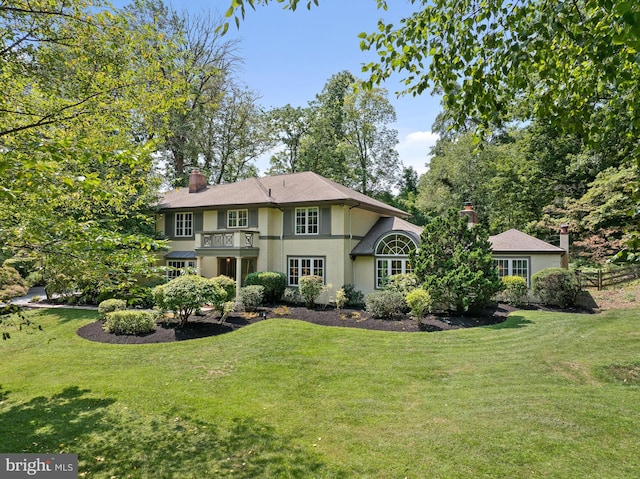 rear view of house featuring a yard