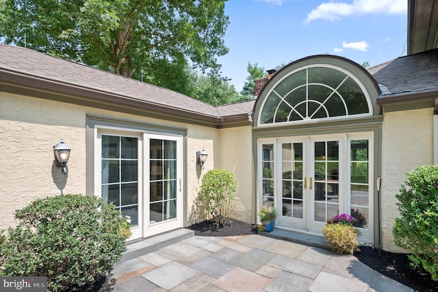 view of exterior entry featuring a patio area and french doors