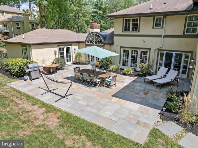 rear view of house with french doors and a patio area