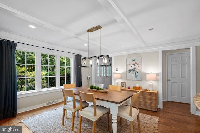 dining space with beamed ceiling and dark hardwood / wood-style floors