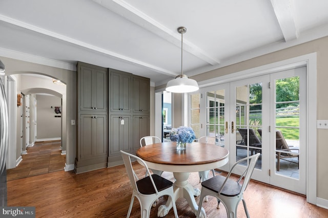 dining area with dark hardwood / wood-style flooring, french doors, and beamed ceiling