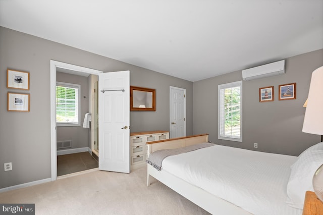 bedroom with multiple windows, light colored carpet, and a wall unit AC