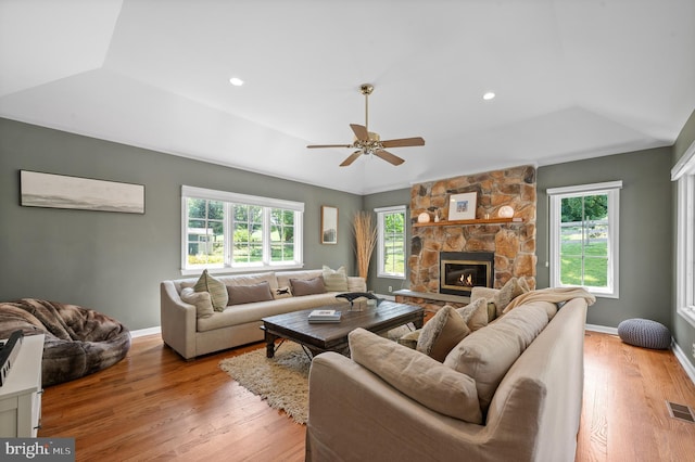 living room with a fireplace, light hardwood / wood-style floors, and ceiling fan