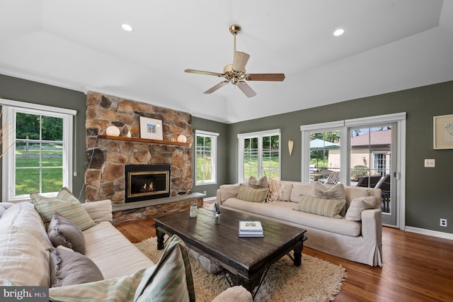 living room featuring ceiling fan, lofted ceiling, a fireplace, and dark hardwood / wood-style flooring