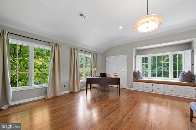 office with vaulted ceiling and light wood-type flooring