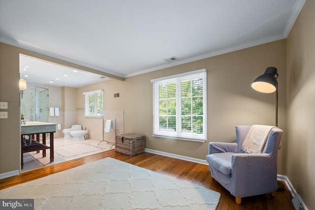 sitting room featuring hardwood / wood-style flooring and crown molding