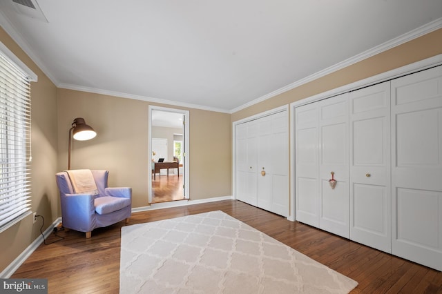 living area featuring ornamental molding and dark hardwood / wood-style floors