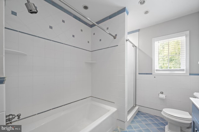 bathroom featuring tile walls, vanity, tile patterned floors, and toilet