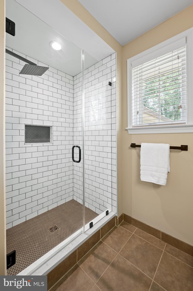 bathroom featuring tile patterned flooring and a shower with shower door