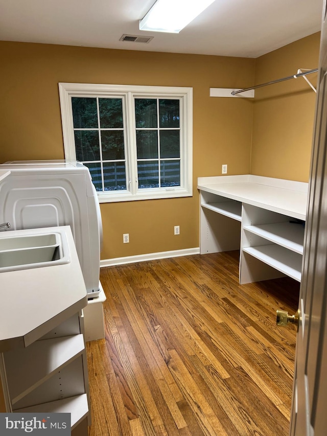 laundry area featuring wood-type flooring