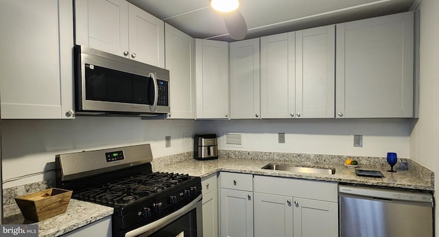 6011 Emerson St Unit 307, Bladensburg, MD 20710 - kitchen featuring light stone counters, stainless steel appliances, sink, and white cabinets