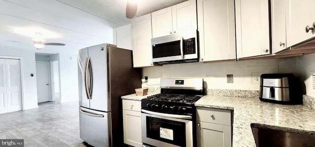 6011 Emerson St Unit 307, Bladensburg, MD 20710 - kitchen featuring light stone countertops, appliances with stainless steel finishes, white cabinets, and ceiling fan