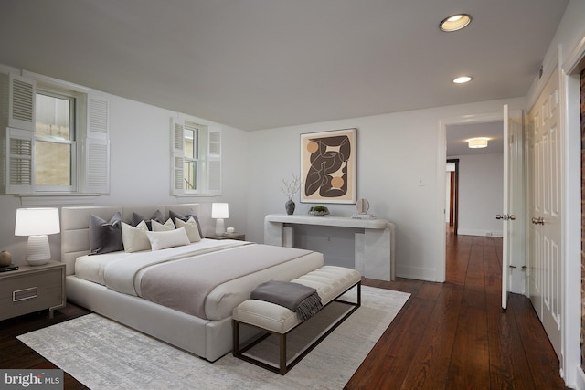 bedroom with dark wood-type flooring