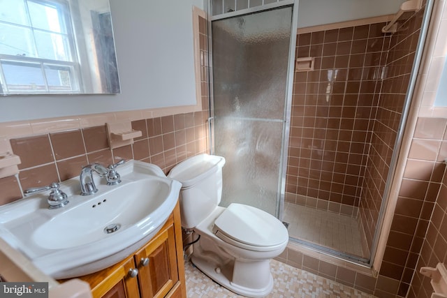 bathroom featuring vanity, toilet, tile walls, and walk in shower