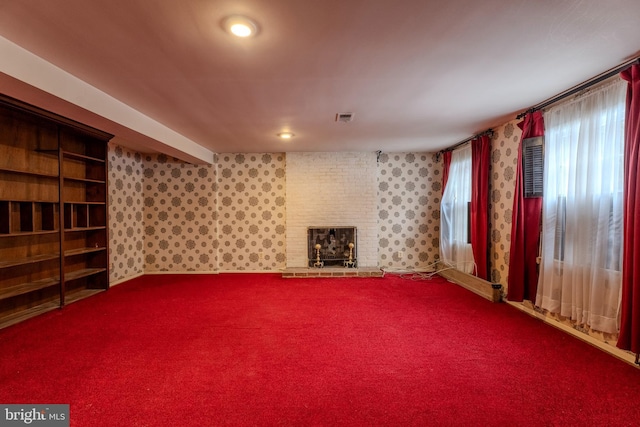 unfurnished living room featuring a fireplace and carpet flooring