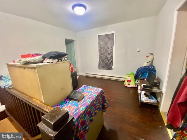 bedroom with baseboard heating and dark wood-type flooring