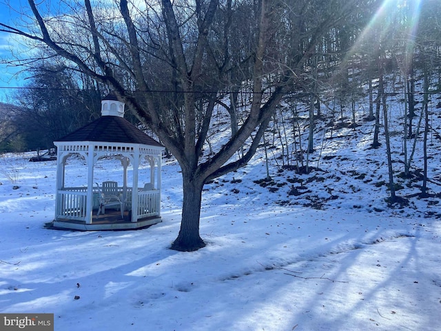 snowy yard with a gazebo